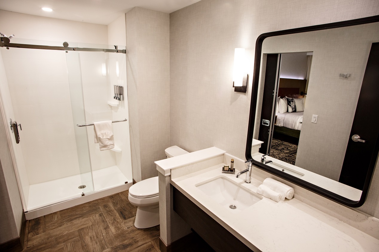 Hotel Rock Lititz bathroom showing white countertops, toilet and standing shower